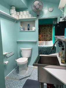 a bathroom with a toilet and a sink at NovaGarden in San Diego