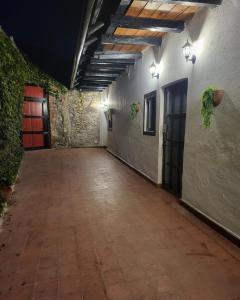 an empty hallway in an old building with a red door at Alojamiento El Fresno in Mineral del Chico +20 photos