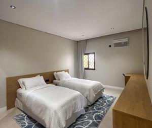 a bedroom with two beds and a window at Maz Apartments in Medina