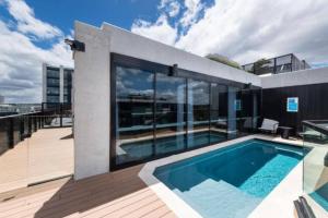 a house with a swimming pool on a roof at CBD - Pool - Sleeps 4 - Parking in Canberra +7 photos