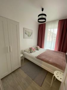 a bedroom with a large bed and a window at BALTIC SUN in Sztutowo