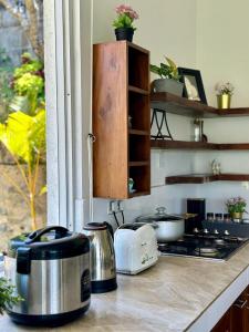 a kitchen counter with pots and pans on a stove at Dream Hills Villa, Nillambe Kandy in Kandy