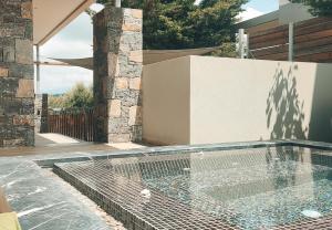 a swimming pool in a backyard with a house at Villa Salvia - Country style luxury & a captivating poolscape in Áyiai Paraskiaí