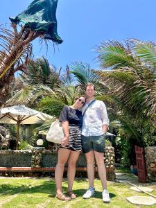 a man and a woman posing for a picture at Sầm Sơn Boutique Hotel Phan Thiết in Phan Thiet