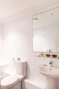 a white bathroom with a toilet and a sink at SACO Bristol West India House in Bristol +93 photos
