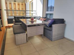 a living room with a table and two chairs at T3 Cocooning au Neptune Saint Gilles-Les-Bains in Saint-Gilles les Bains