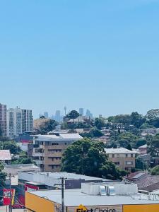 a view of a city with buildings and trees at Stylish Apartment with city view close to beach airport cbd in Sydney