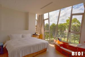 una camera da letto con un letto e una grande finestra di Star Deco Resort a Dongshan