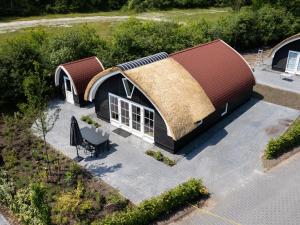 an overhead view of a house with a grass roof at House with a terrace on the edge of the forest in Baars