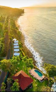 an aerial view of a beach and the ocean at Bali Cliff Glamping in Karangasem