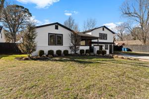 a white house with a yard at Villa Bella elegant family retreat in downtown in Bentonville