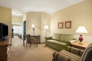 a living room with a couch and a television at Country Inn & Suites by Radisson, Beckley, WV in Beckley