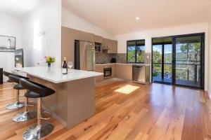 a kitchen with a island in the middle of a room at Crown Cottage in Smiths Lake