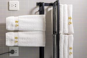 a group of towels on a towel rack in a bathroom at Yise Serviced Apartment -Beijing CCTV Shop in Beijing