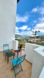 2 sedie blu e un tavolo sul balcone di Royal Pearl Hills a Nuwara Eliya