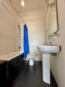 La salle de bains est pourvue d'un lavabo, de toilettes et d'une baignoire. dans l'établissement Royal Pearl Hills, à Nuwara Eliya