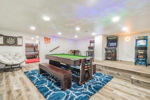 a living room with a pool table and a tv at Arcade Palace on the Lake in Garfield