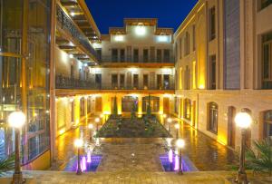 an indoor courtyard of a building at night at CARAVAN PLAZA BOUTIQUE in Bukhara