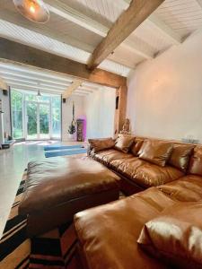 a large living room with a couch and a table at Sauna + Spa @ Boho House on Bowen Island in Bowen Island