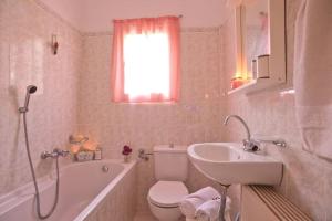 a bathroom with a toilet and a sink and a bath tub at Levanda seaview in Corfu