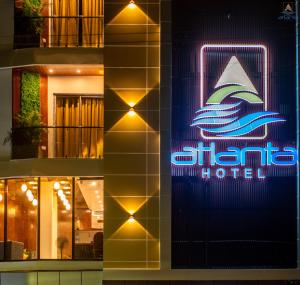 un cartello per un hotel sul lato di un edificio di Hotel Atlanta - A Seaview Hotel a Port Blair