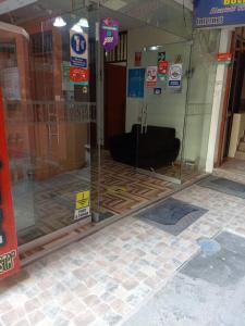 a glass door of a building with a black object inside at HOSPEDAJE BUENA VISTA in Ayacucho