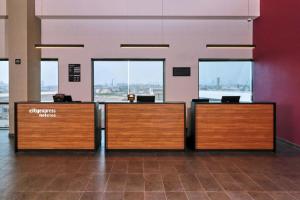 a lobby with two reception desks in a building at City Express by Marriott Monterrey Universidad in Monterrey