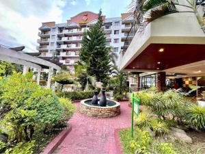 a courtyard with a fountain in front of a building at 2BR Kelsey Haven With Balcony in Davao City