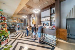 a group of people standing at a counter in a store at Condo • WIFI up to 100mbps • Infinity Pool in Cebu City +24 photos