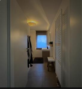 a hallway with a bathroom with a sink and a window at Fewo Spectrum in Überlingen