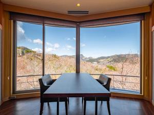 a dining room with a table and a large window at Nagominoyado Hanagokoro - Reopening in Mar 2024 in Hakone