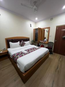 a bedroom with a large bed in a room at The Century Plaza Hotel in Varanasi