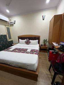 a hotel room with a bed and a desk at The Century Plaza Hotel in Varanasi