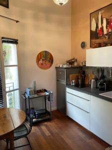 a kitchen with a sink and a table and a counter at JOHA DOMA in Lunel