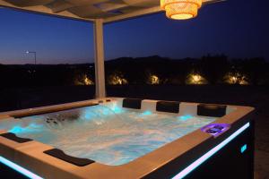 a hot tub on a patio at night at S-EVA RESORT in Kolymbia