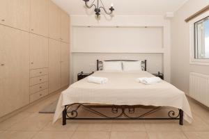 Ένα ή περισσότερα κρεβάτια σε δωμάτιο στο Creta Luxury Villas