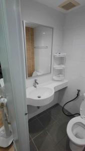 a bathroom with a sink and a toilet at Lumpini Prachachaeun Great condo near Lumpini Park in Ban Bang Khen (1)