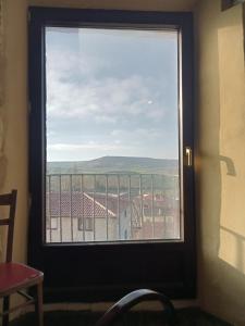 a window in a room with a view of a building at Albergue de peregrinos Casa Nostra in Castrojeriz