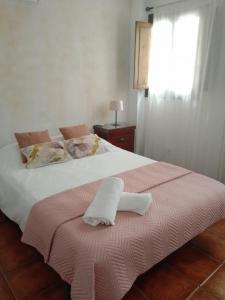 Una cama con una toalla blanca encima. en Claustro Home Casco Histórico Córdoba, en Córdoba