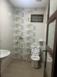 a bathroom with a shower and a toilet and a sink at Nhật Vân 2 in Ho Chi Minh City