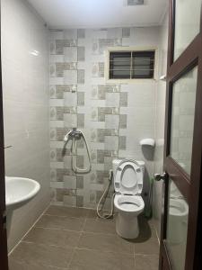 a bathroom with a shower and a toilet and a sink at Nhật Vân 2 in Ho Chi Minh City