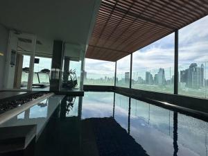 a swimming pool in a building with a view of the city at S42 Wyndham Garden Sukhumvit BTS Ekkamai Gym Swim in Bangkok