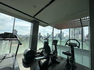 a gym with several cardio machines in a building at S42 Wyndham Garden Sukhumvit BTS Ekkamai Gym Swim in Bangkok
