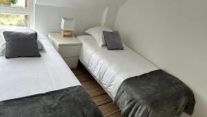 een kamer met twee bedden en een lamp op een tafel bij Bel Appartement Saint-Malo la Varde in Saint-Malo