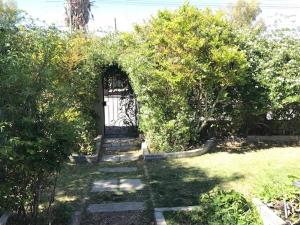 a door in a garden with a grass yard at Hannah's Haven in Beaufort West