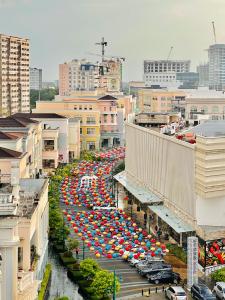 a street filled with lots of umbrellas in a city at 2* * Contemporary Comfort in Iloilo City