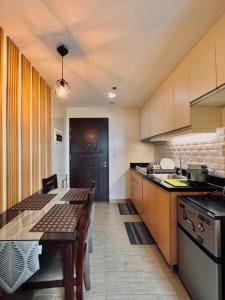 a kitchen with a table and a counter top at 1 Urban Elegance in Iloilo City