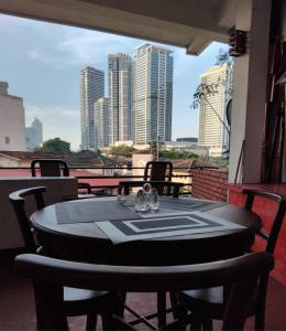 a table on a balcony with a view of the city at Regent Residencies - Colombo in Colombo