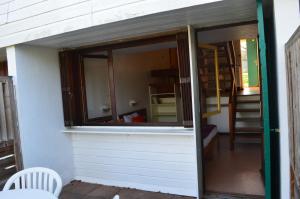a sliding glass door on a building with a window at Résidence Parc Les Cigognes Albé in Albé