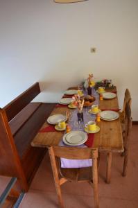 a wooden table with plates of food on it at Résidence Parc Les Cigognes Albé in Albé +12 photos